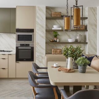 The bespoke kitchen we designed at our Knightsbridge project. This one was a huge transformation from a former dark gallery kitchen to a large airy kitchen with banquet seating and lots of storage. We mixed up all the finishes from timber to reeded glass and a smooth liquid metal finish to keep it interesting with so much cabinetry. By taking the splash-back up full height to the ceiling by the open shelves it drawers your eye up and gives the illusion of higher ceilings. Everything in here was custom made but the lamps are available from @portaromanauk #luxinteriors #kitchen #kitchendesign #luxuryliving 📷 @raymain57